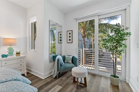 a dining room with furniture water view and a floor to ceiling window