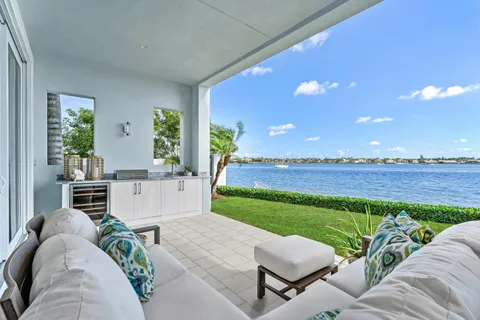a view of a house with backyard porch and sitting area