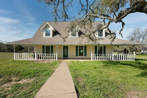 a front view of a house with a yard table and chairs