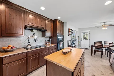 a kitchen that has a table and chairs in it