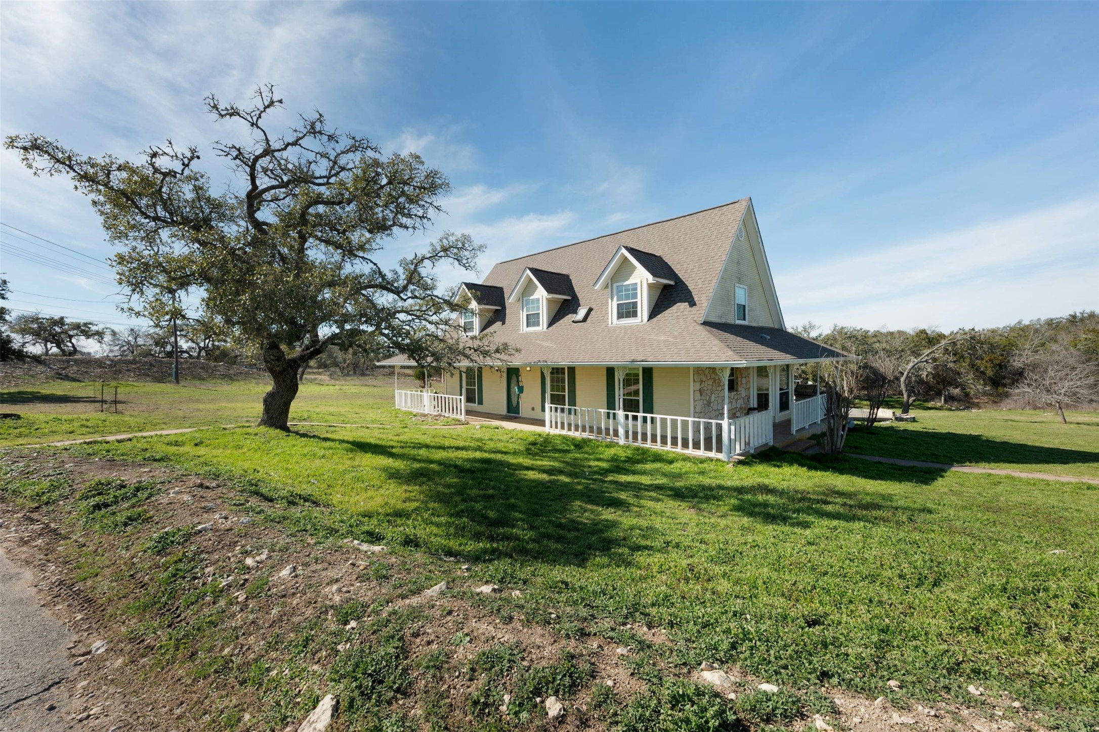 31305 Ranch Road 12 Dripping Springs, TX 78620 - Photo 2 of 32 a front view of a house with garden