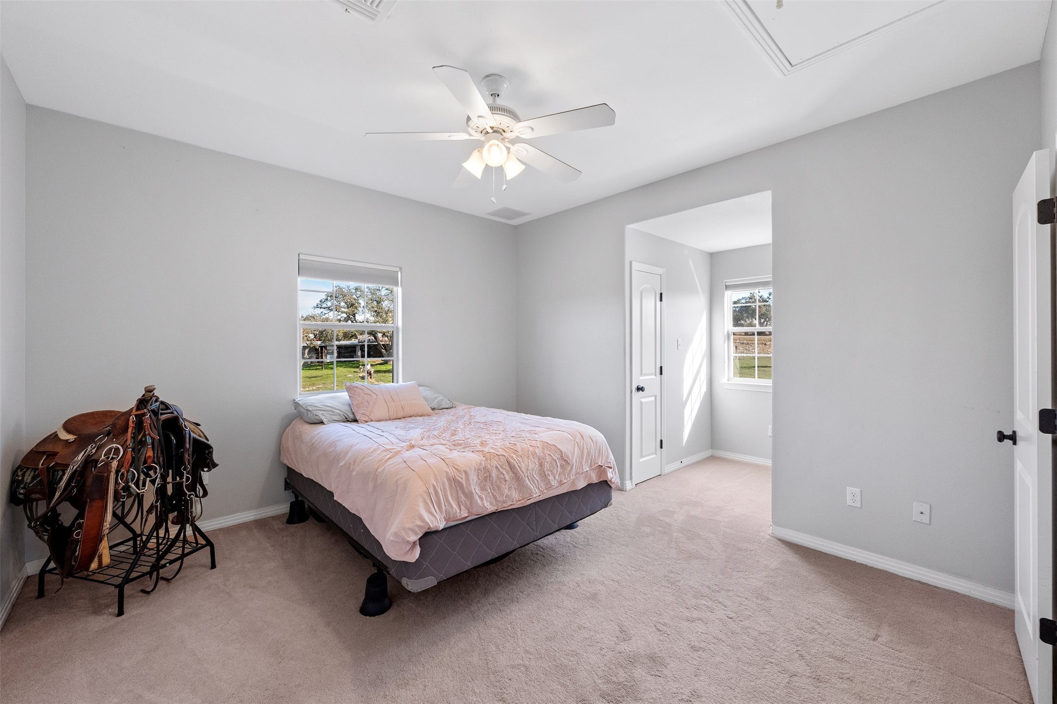 31305 Ranch Road 12 Dripping Springs, TX 78620 - Photo 21 of 32 a spacious bedroom with a bed and a chandelier