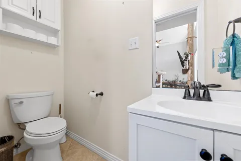 a bathroom with a sink a toilet and mirror