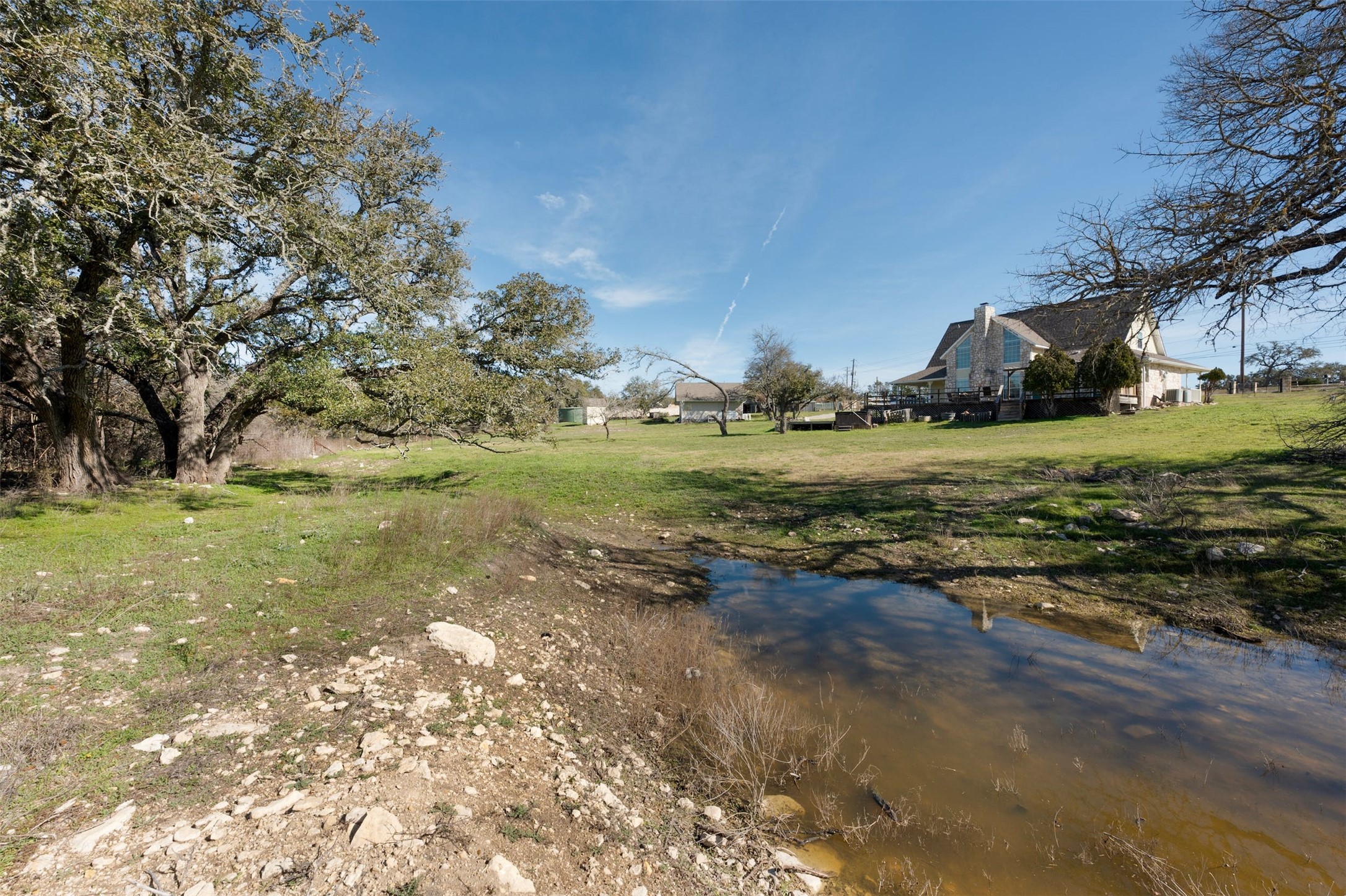31305 Ranch Road 12 Dripping Springs, TX 78620 - Photo 31 of 32 a view of a field with an trees