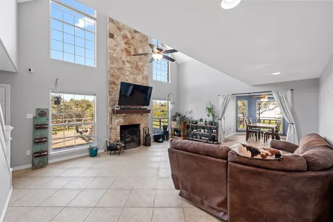 a living room with furniture a fireplace and a flat screen tv