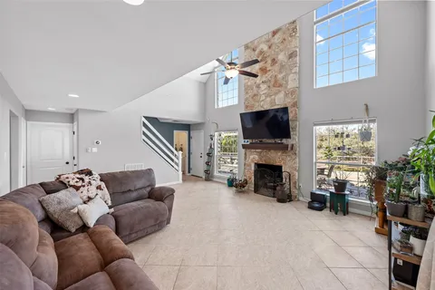 a living room with furniture a fireplace and a flat screen tv