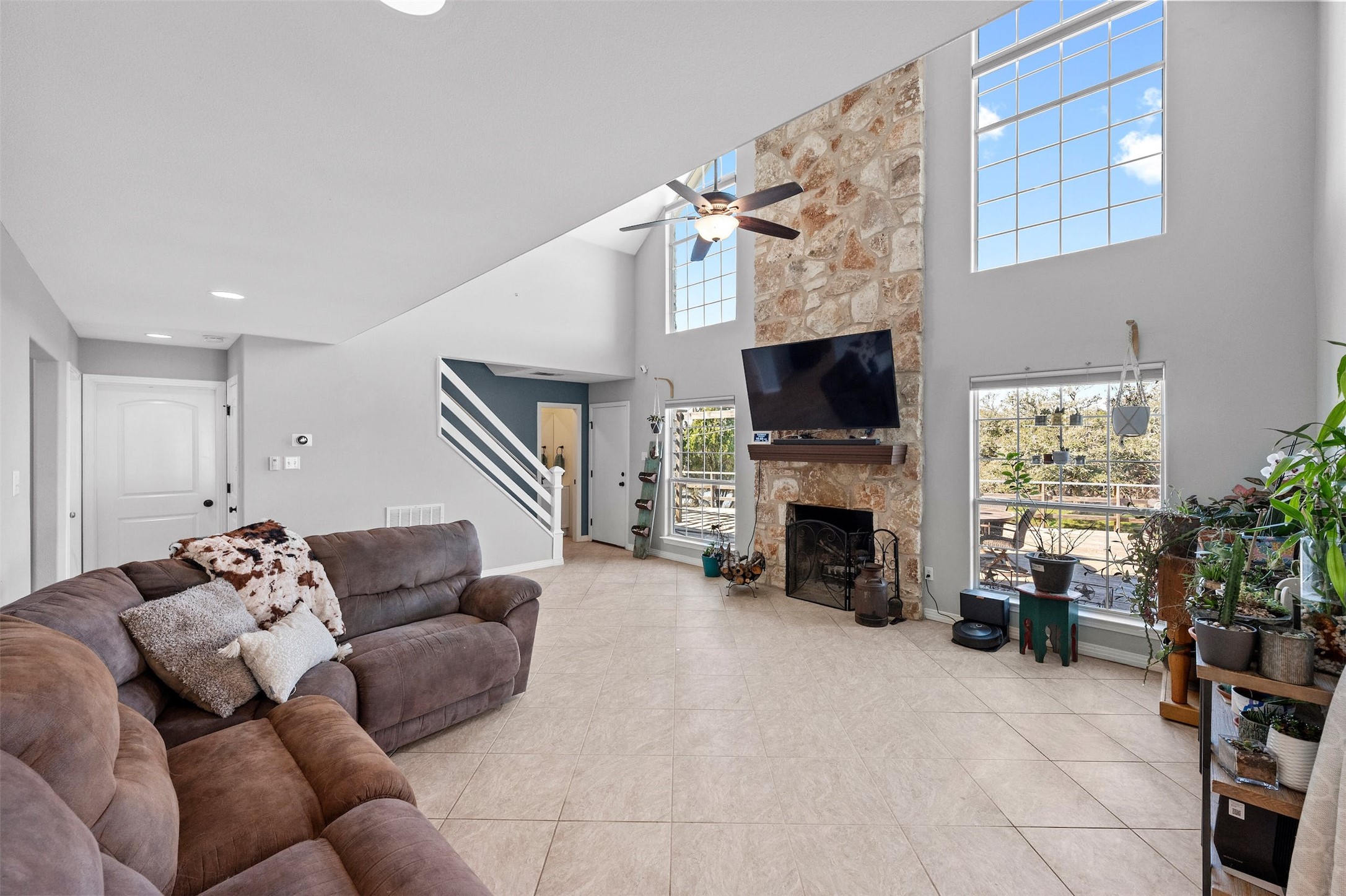 31305 Ranch Road 12 Dripping Springs, TX 78620 - Photo 7 of 32 a living room with furniture a fireplace and a flat screen tv
