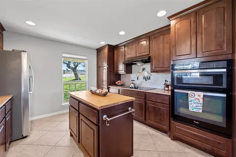 a kitchen with stainless steel appliances a stove a sink and a microwave
