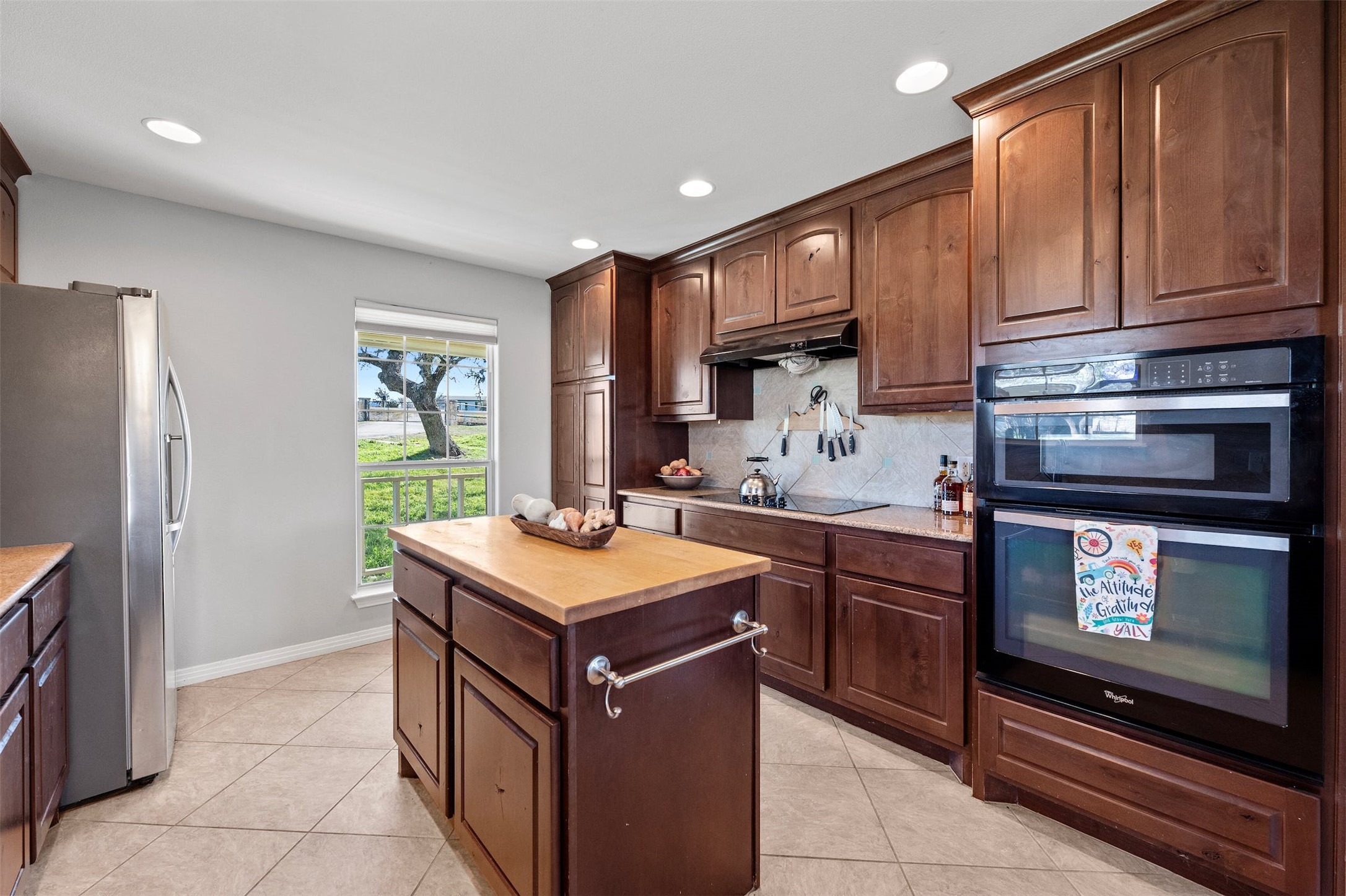 31305 Ranch Road 12 Dripping Springs, TX 78620 - Photo 9 of 32 a kitchen with stainless steel appliances a stove a sink and a microwave