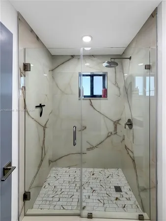 a bathroom with a shower and a sink