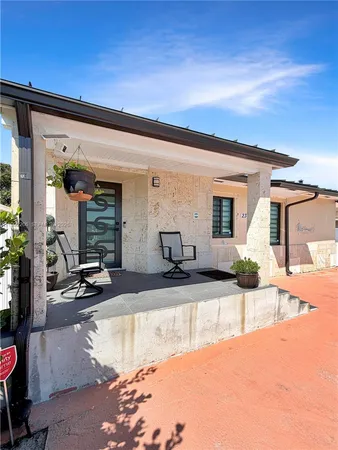 a kitchen with granite countertop a refrigerator and a stove top oven