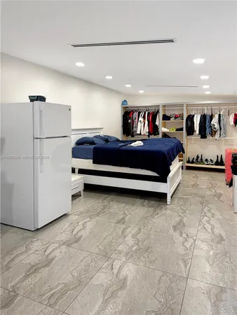 a view of a room with utility room and refrigerator
