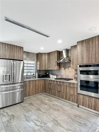 a stove top oven sitting inside of a kitchen
