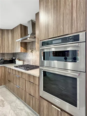 a kitchen with a stove a refrigerator and cabinets