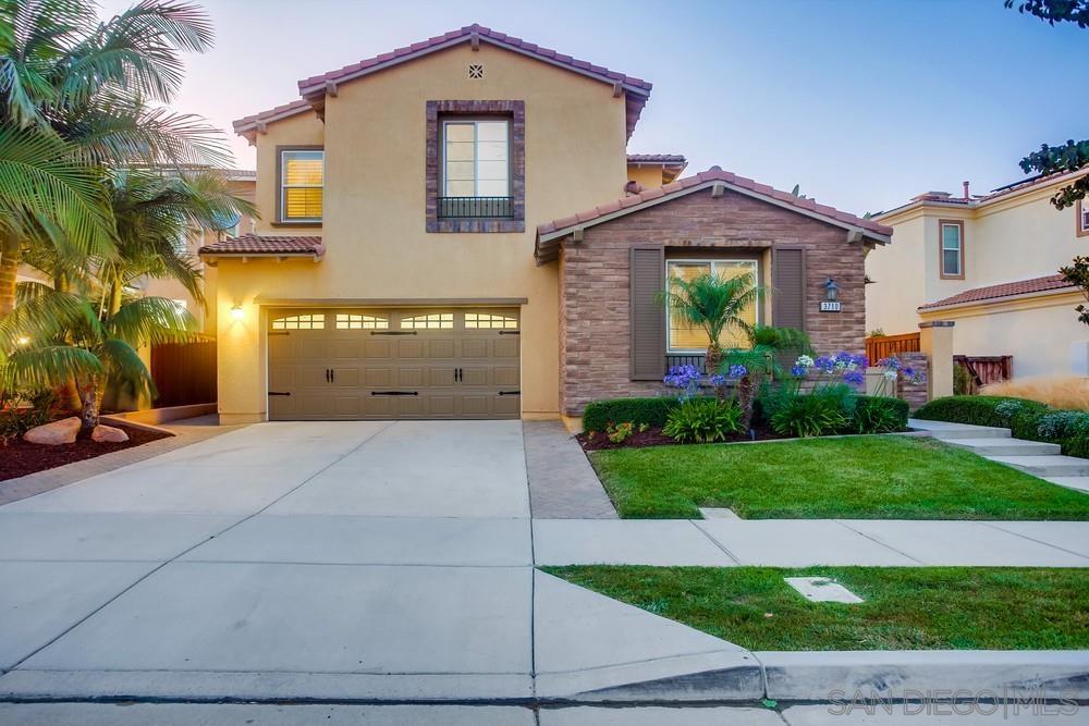 3710 Bergen Peak Place Carlsbad, CA 92010 - Photo 1 of 38 a front view of a house with a yard and garage