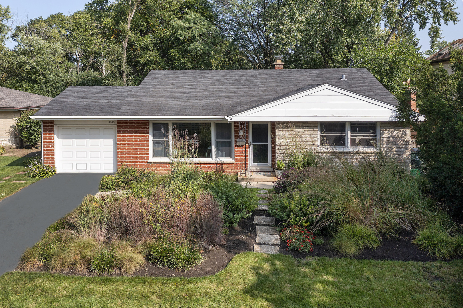 1345 Tinker Way Glenview, IL 60025 - Photo 1 of 25 a front view of a house with a yard and potted plants