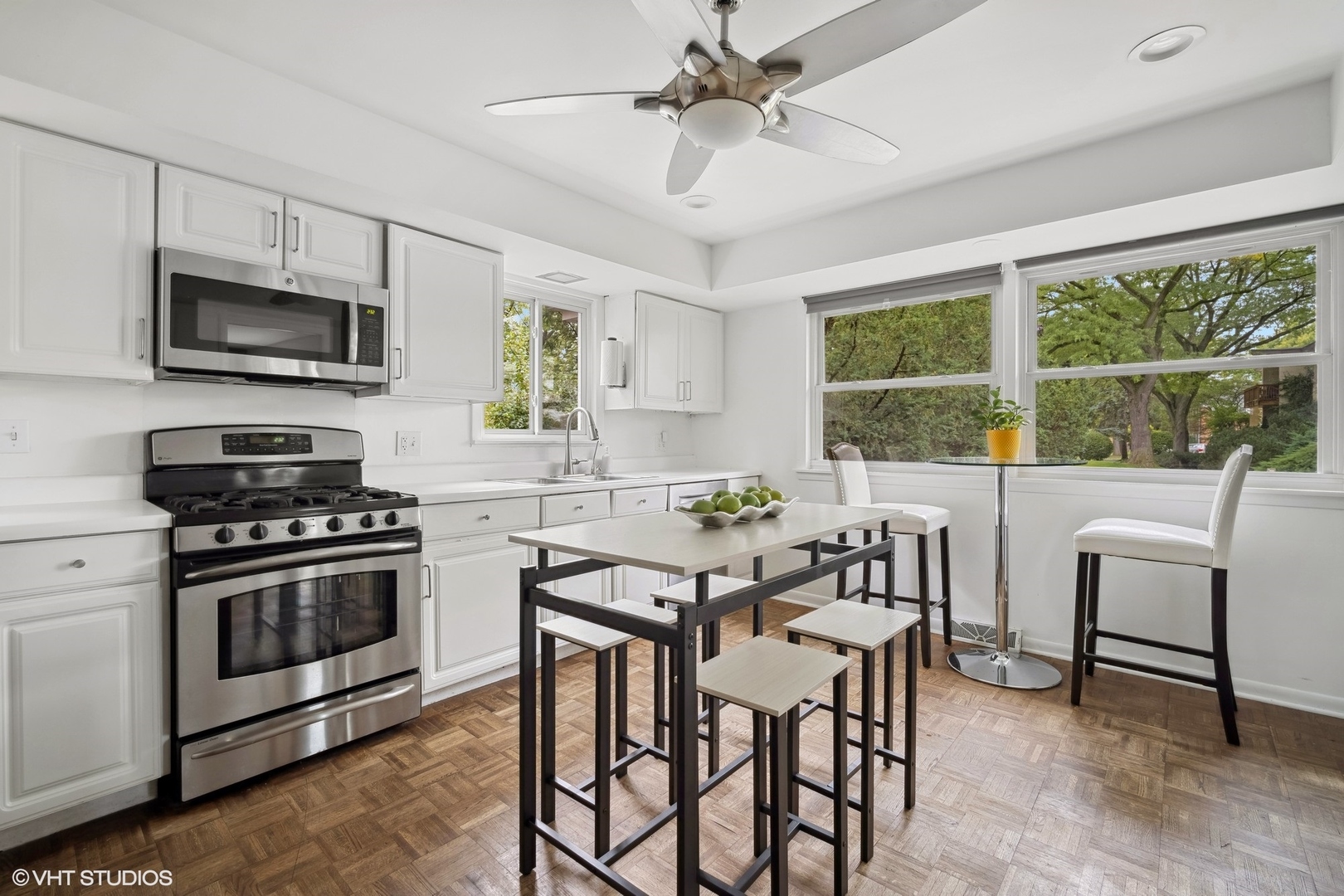 1345 Tinker Way Glenview, IL 60025 - Photo 11 of 25 a kitchen with stainless steel appliances a stove a sink a microwave a dining table and chairs