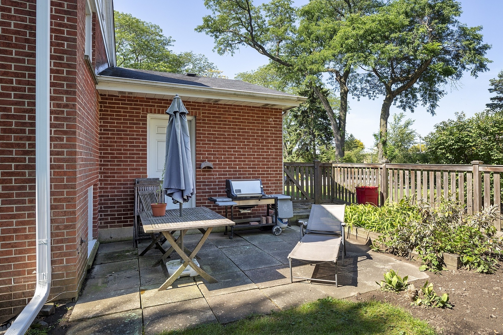 1345 Tinker Way Glenview, IL 60025 - Photo 24 of 25 a view of a chairs and table in the back yard of the house