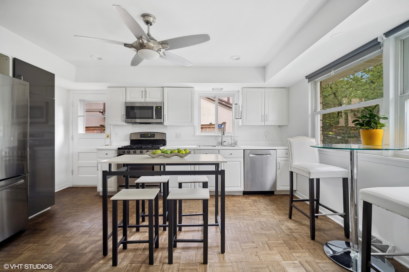 1345 Tinker Way Glenview, IL 60025 - Photo 8 of 25 a kitchen with a dining table chairs and refrigerator