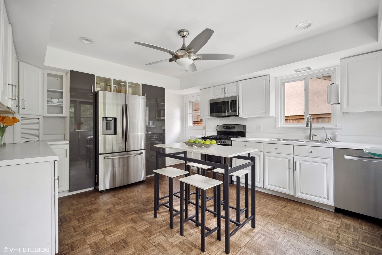 1345 Tinker Way Glenview, IL 60025 - Photo 9 of 25 a kitchen with stainless steel appliances granite countertop a refrigerator a stove a sink a dining table and chairs with wooden floor
