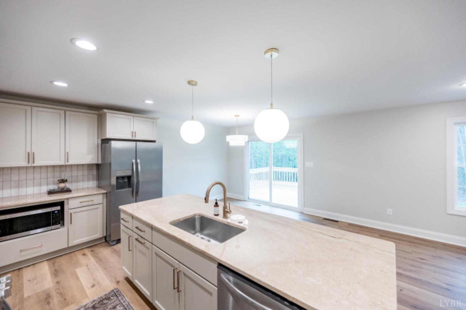 240 Ned Brown Road Amherst, VA 24521 - Photo 11 of 59 a kitchen with a sink a counter space appliances and cabinets