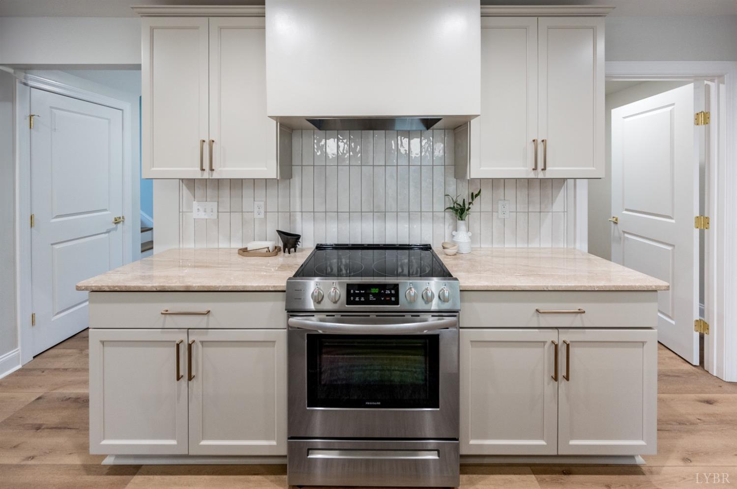 240 Ned Brown Road Amherst, VA 24521 - Photo 13 of 59 a kitchen with white cabinets and white appliances