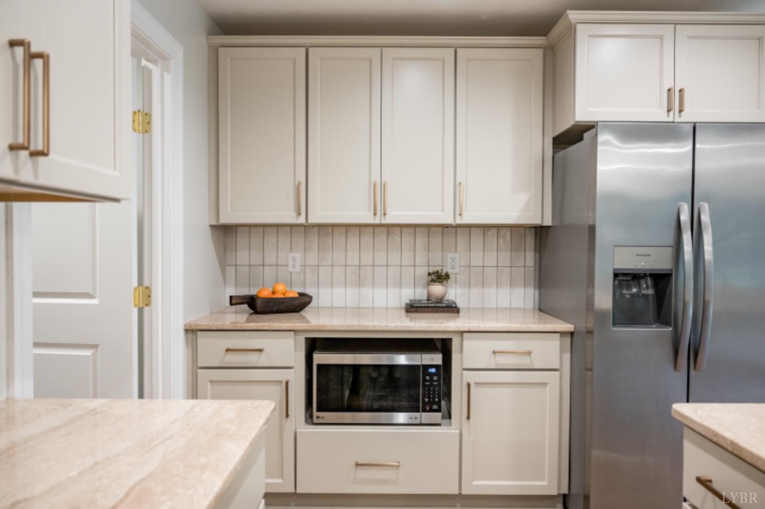 240 Ned Brown Road Amherst, VA 24521 - Photo 23 of 59 a kitchen with granite countertop a sink stove and refrigerator
