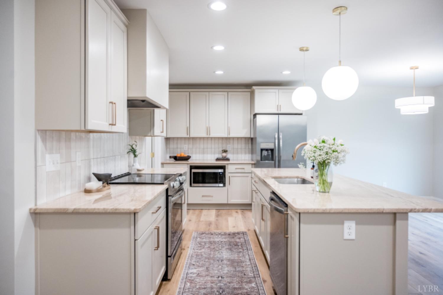 240 Ned Brown Road Amherst, VA 24521 - Photo 29 of 59 a kitchen with a sink a counter top space cabinets and stainless steel appliances