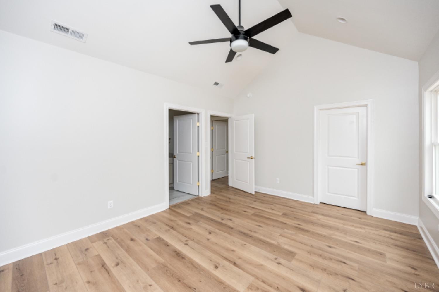 240 Ned Brown Road Amherst, VA 24521 - Photo 40 of 59 a view of a big room with wooden floor and a ceiling fan