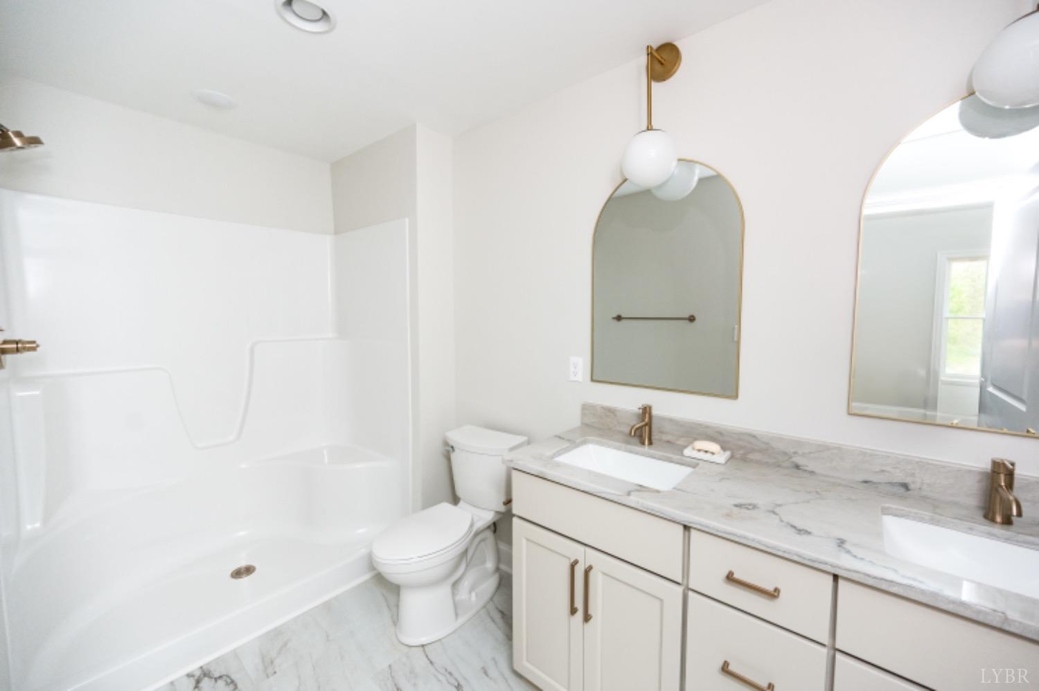 240 Ned Brown Road Amherst, VA 24521 - Photo 41 of 59 a bathroom with a granite countertop sink a toilet and a mirror
