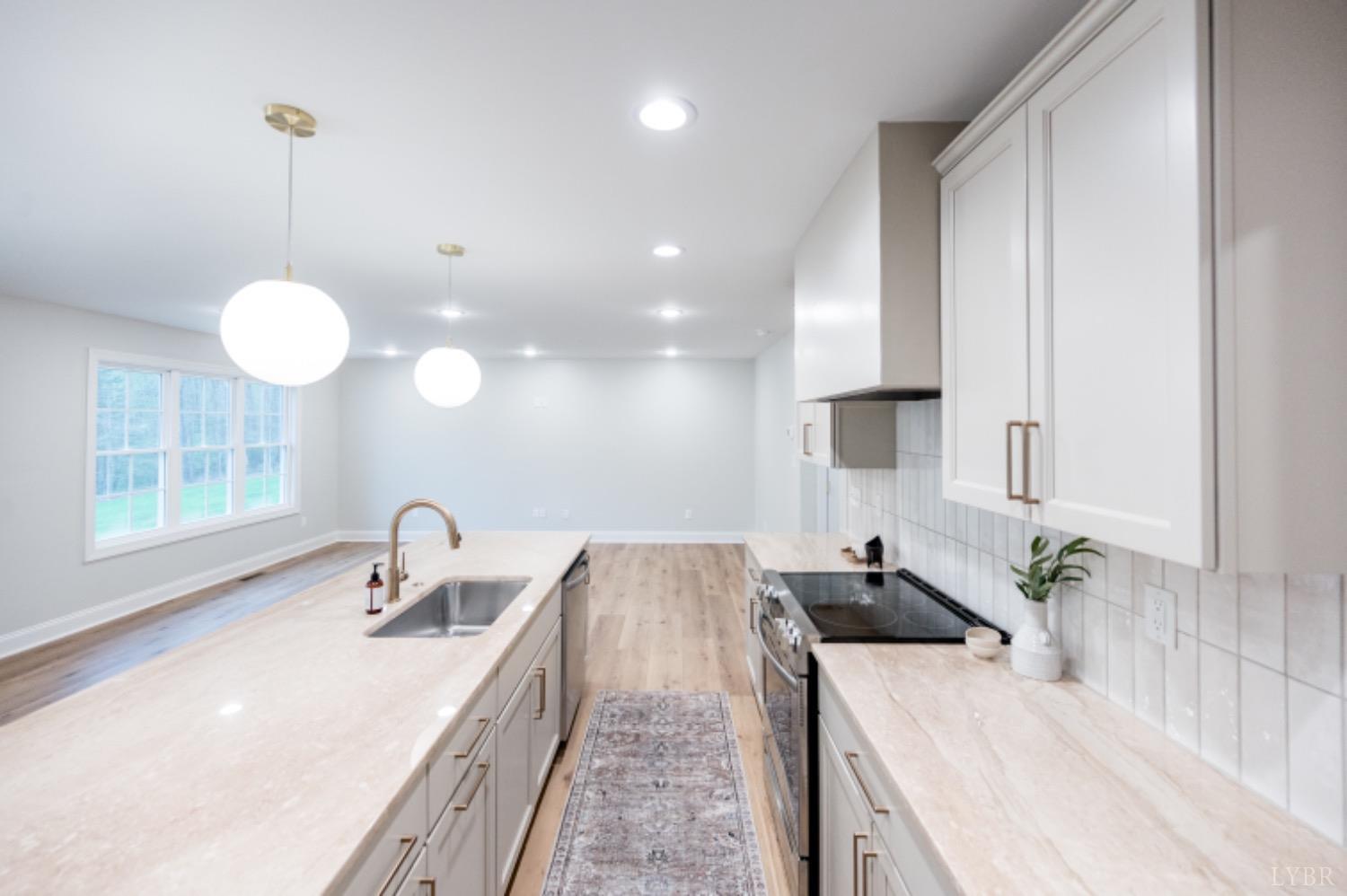 240 Ned Brown Road Amherst, VA 24521 - Photo 7 of 59 a kitchen with stainless steel appliances granite countertop a sink a stove and a wooden floors