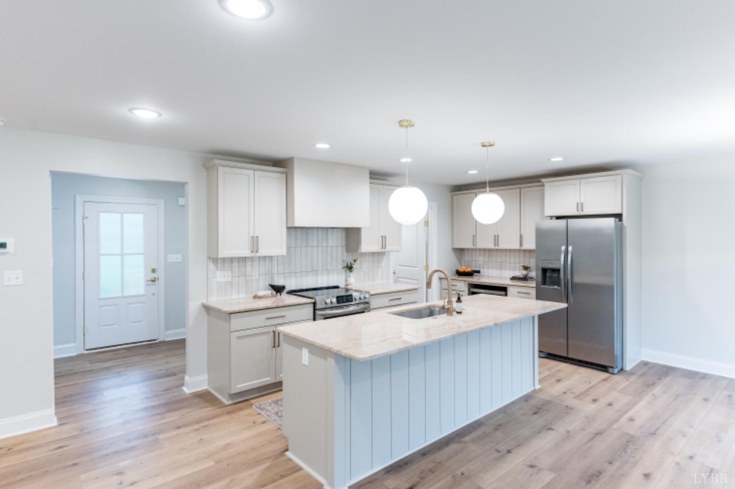 240 Ned Brown Road Amherst, VA 24521 - Photo 9 of 59 a kitchen with a sink a counter top stainless steel appliances and cabinets