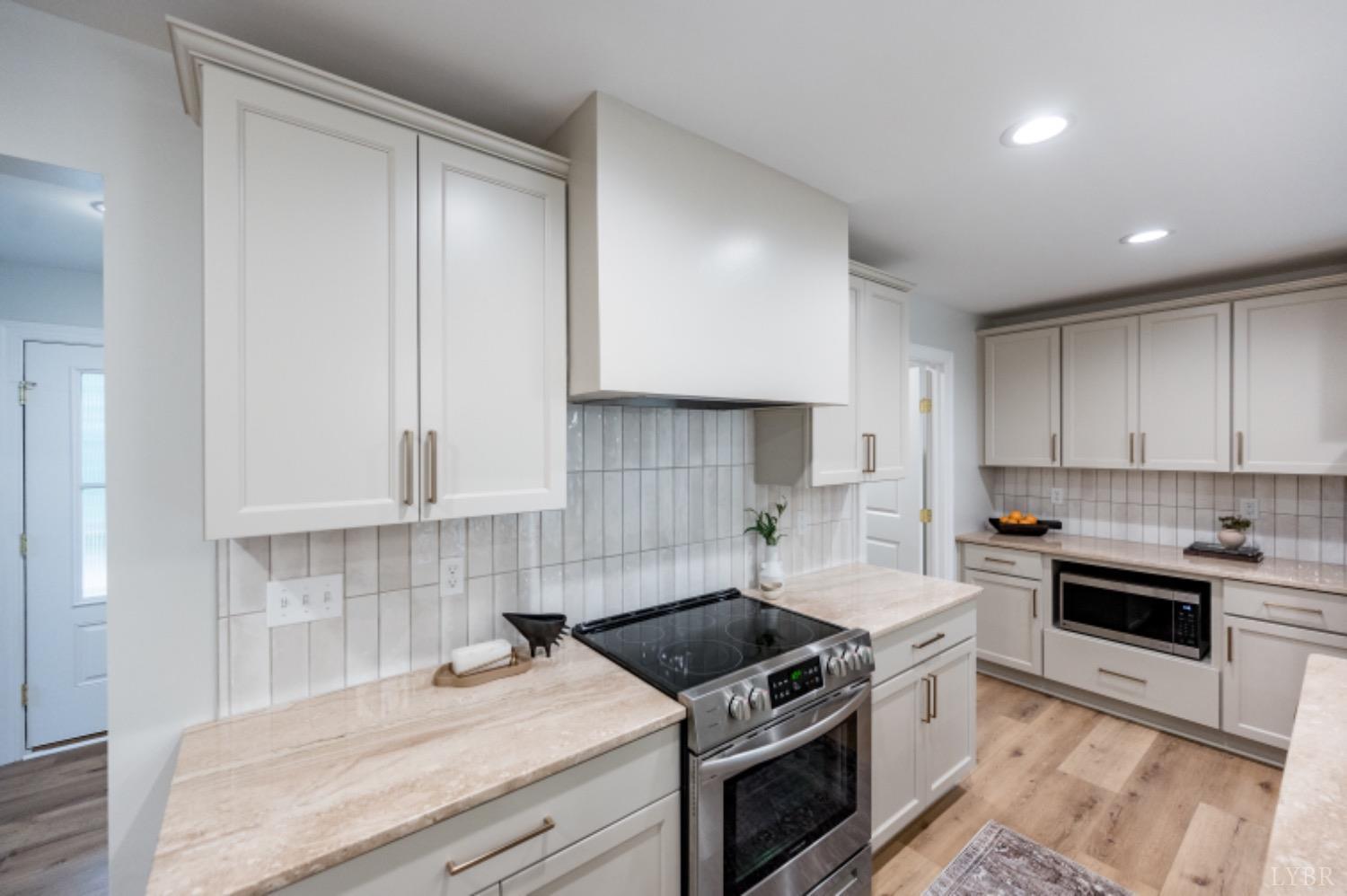 240 Ned Brown Road Amherst, VA 24521 - Photo 10 of 59 a kitchen with a stove sink and cabinets