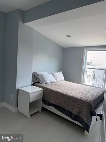 a kitchen with white cabinets and refrigerator