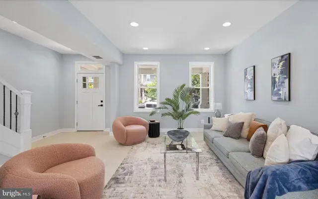 a living room with furniture and a large window