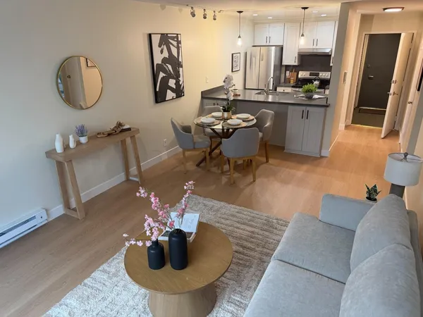 a living room with furniture and kitchen view