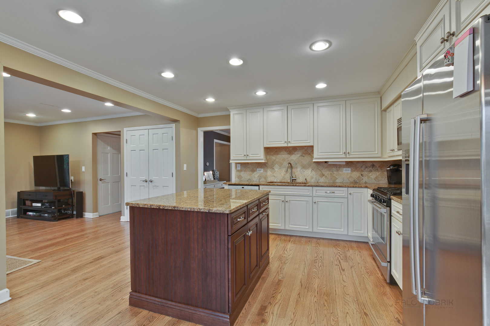 1040 Forest Hill Road Lake Forest, IL 60045 - Photo 12 of 30 a kitchen with kitchen island granite countertop a sink and refrigerator