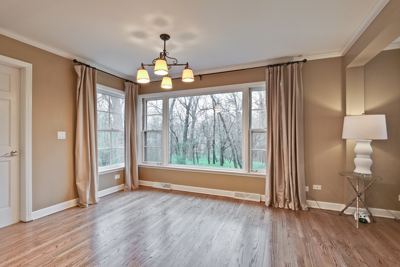 1040 Forest Hill Road Lake Forest, IL 60045 - Photo 8 of 30 a view of an empty room with wooden floor and a window