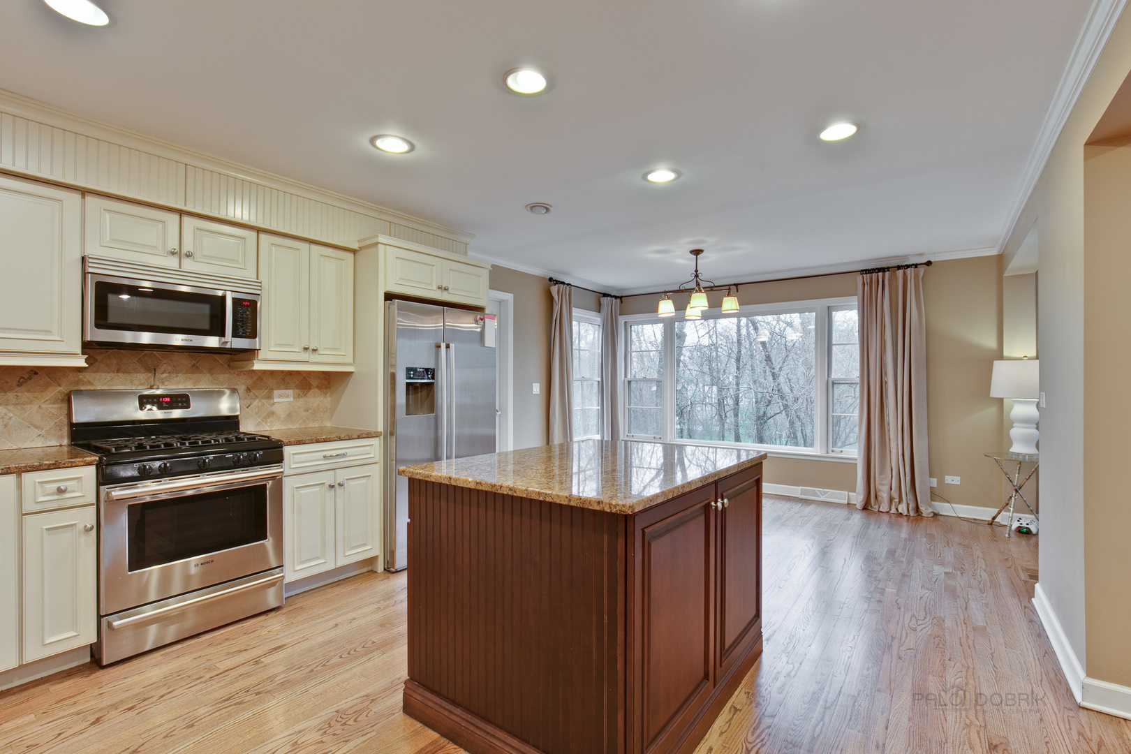 1040 Forest Hill Road Lake Forest, IL 60045 - Photo 9 of 30 a kitchen with kitchen island granite countertop a stove and a wooden floors
