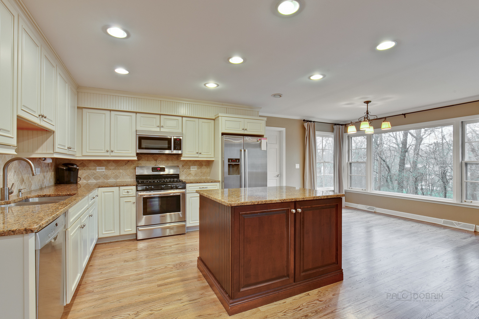 1040 Forest Hill Road Lake Forest, IL 60045 - Photo 10 of 30 a kitchen with stainless steel appliances granite countertop a stove top oven a sink dishwasher a refrigerator and a refrigerator with wooden floor