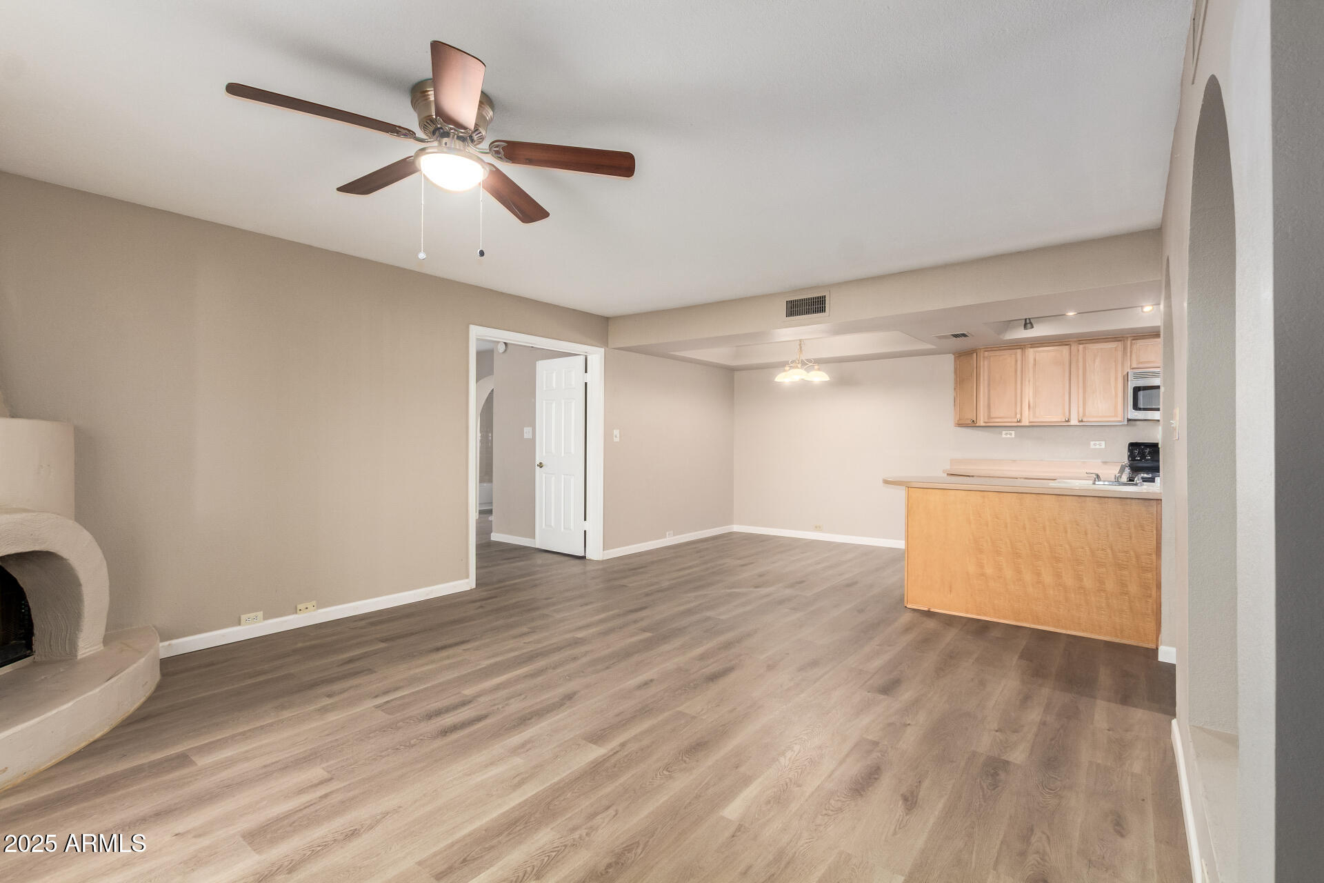 10410 North Cave Creek Road, Unit 1011 Phoenix, AZ 85020 - Photo 11 of 41 a view of an empty room with wooden floor and a window