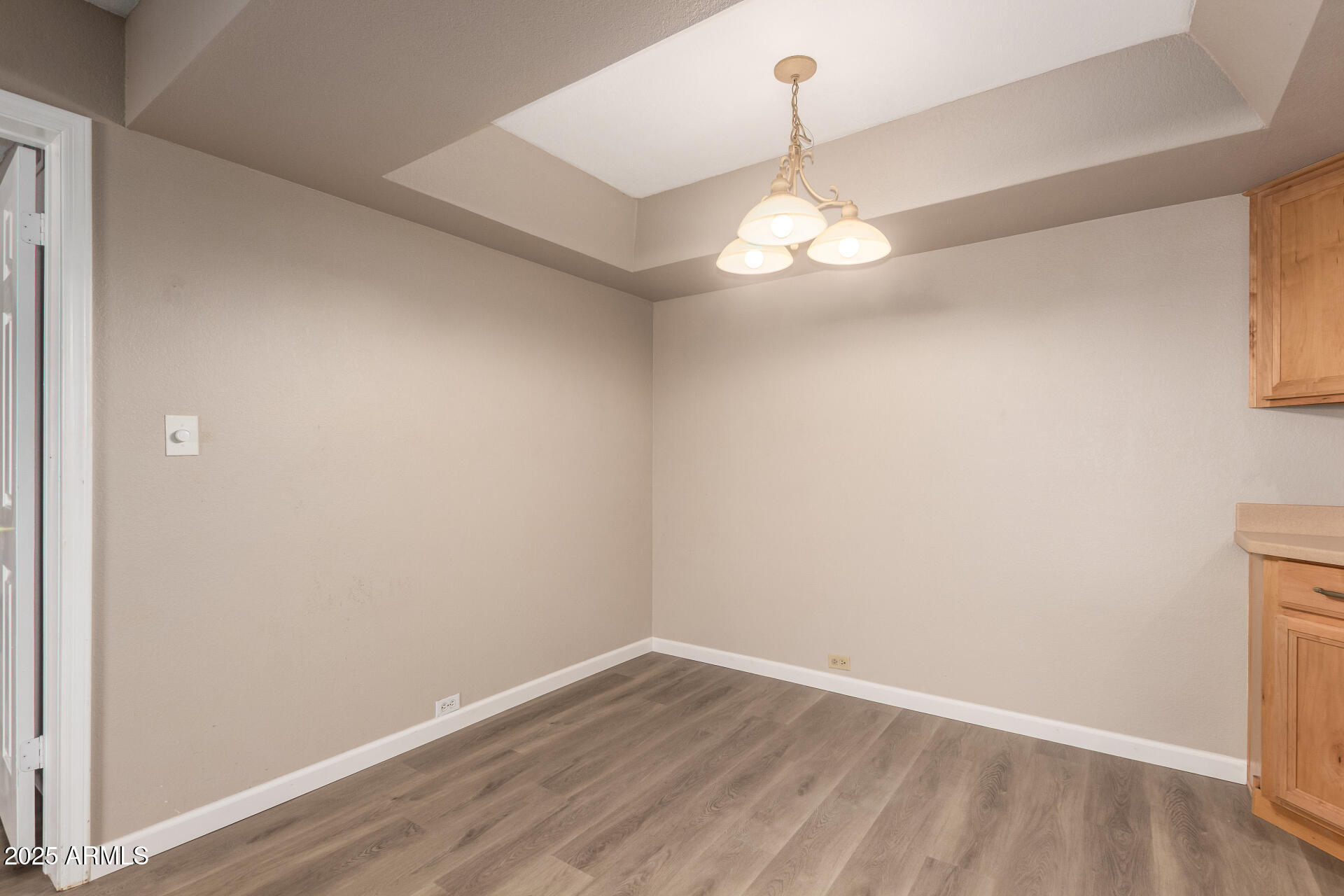 10410 North Cave Creek Road, Unit 1011 Phoenix, AZ 85020 - Photo 12 of 41 an empty room with wooden floor and windows