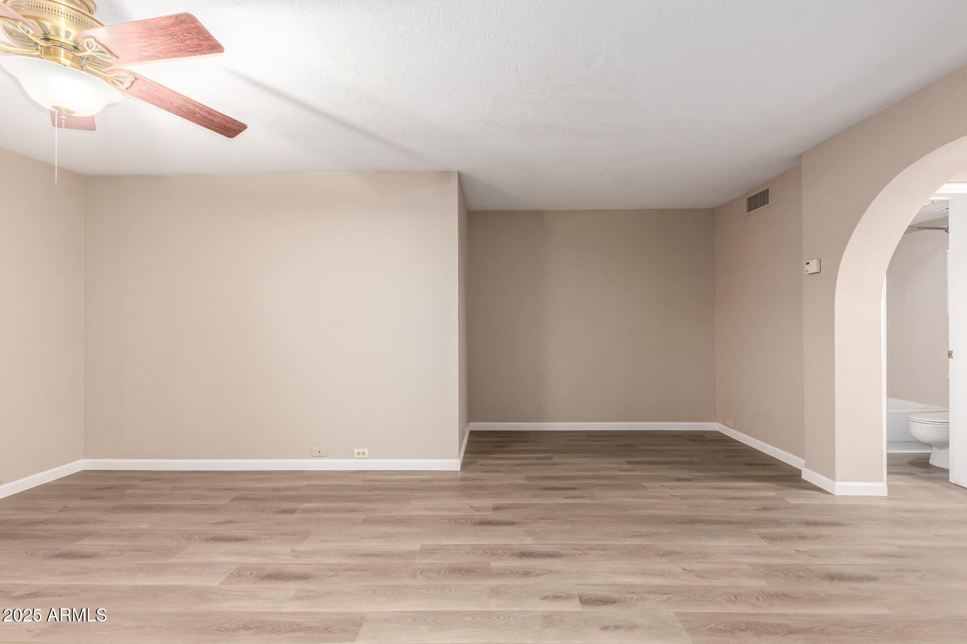 10410 North Cave Creek Road, Unit 1011 Phoenix, AZ 85020 - Photo 20 of 41 a view of an empty room with wooden floor