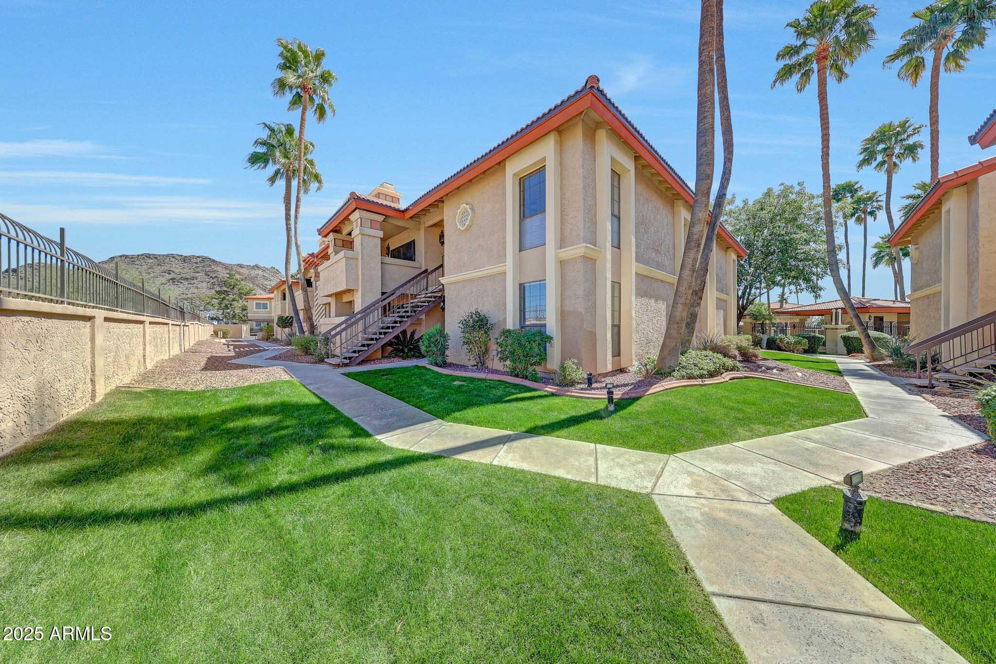 10410 North Cave Creek Road, Unit 1011 Phoenix, AZ 85020 - Photo 3 of 41 a view of a house with a yard