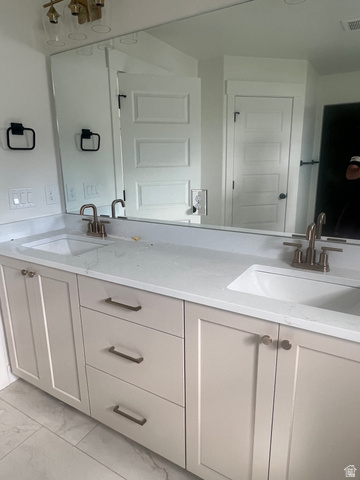 4740 West 25 North West Point, UT 84015 - Photo 10 of 15 Dual vanity with light-colored cabinetry and stone-finish countertops