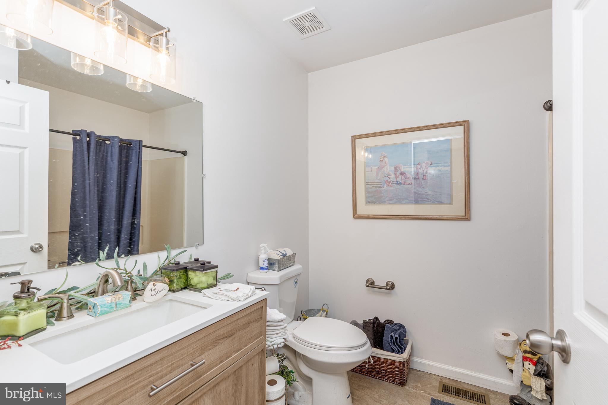 1030 Center Street Tuckerton, NJ 08087 - Photo 27 of 42 a bathroom with a granite countertop sink mirror vanity and toilet