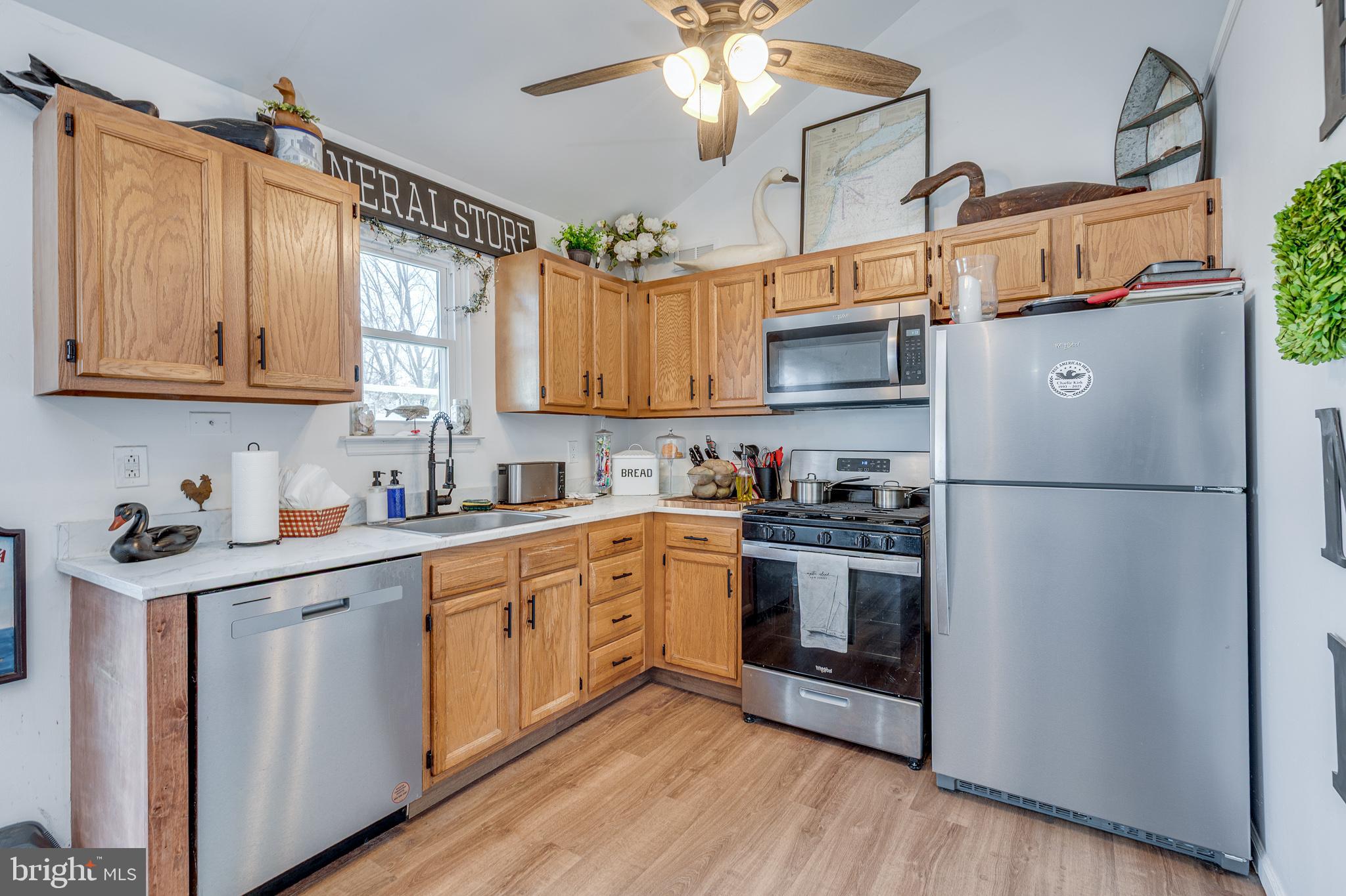 1030 Center Street Tuckerton, NJ 08087 - Photo 8 of 42 a kitchen with stainless steel appliances granite countertop a refrigerator a sink dishwasher a stove and white countertops with wooden floor