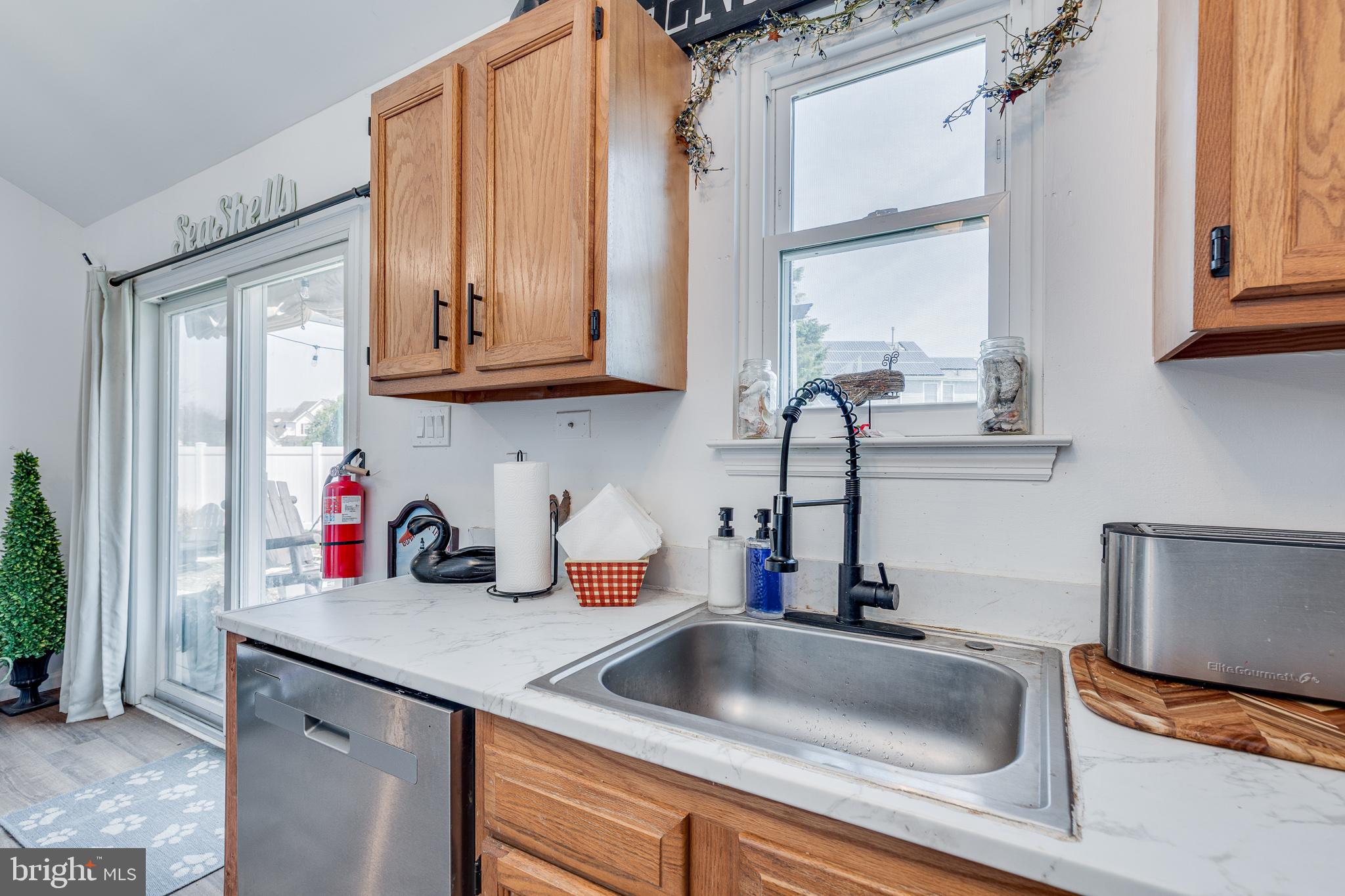 1030 Center Street Tuckerton, NJ 08087 - Photo 9 of 42 a kitchen with granite countertop a sink stainless steel appliances and cabinets