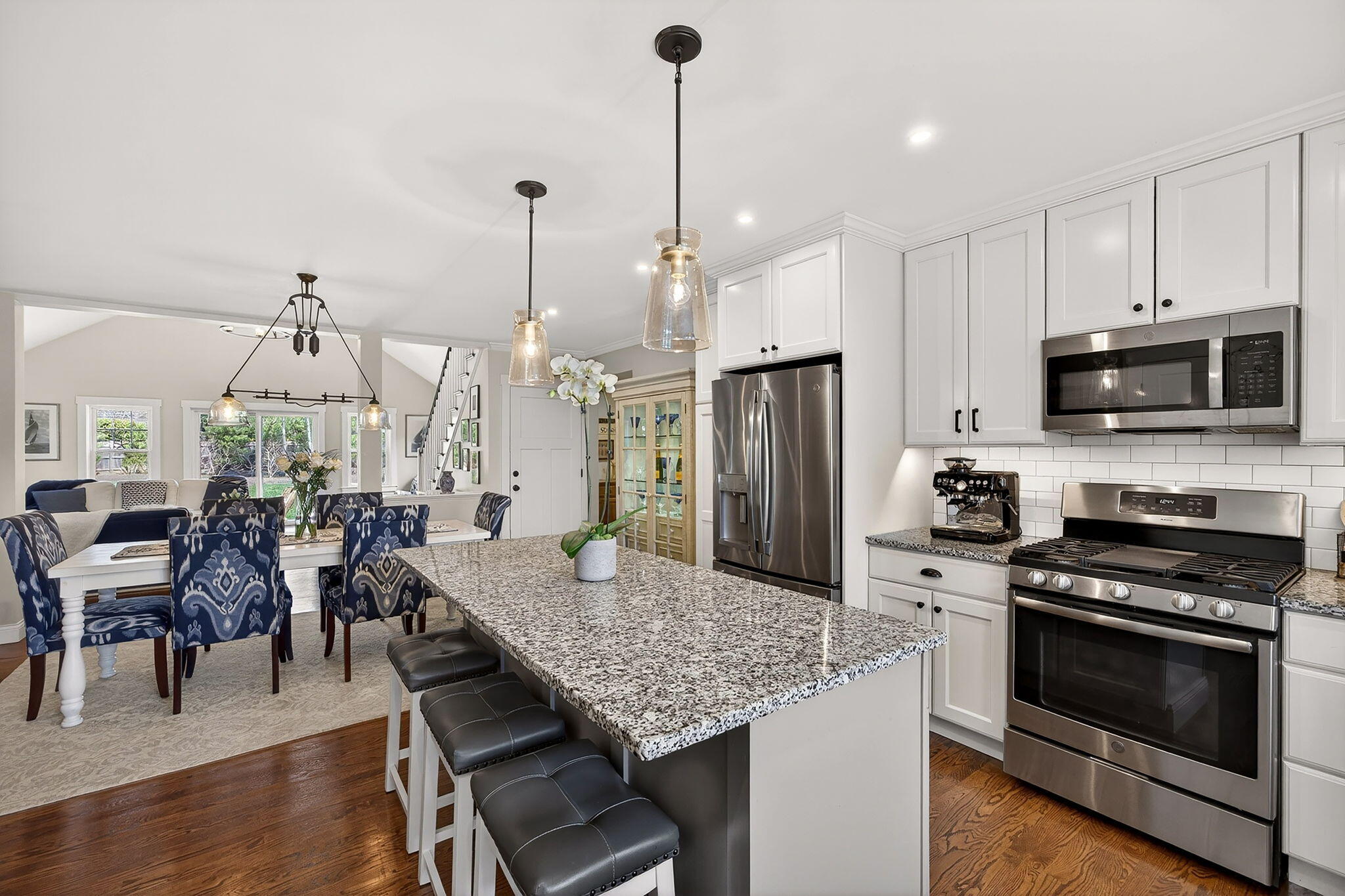 176 Bumps River Road Osterville, MA 02655 - Photo 8 of 54 a kitchen with stainless steel appliances kitchen island granite countertop a stove a refrigerator a kitchen island a dining table and chairs