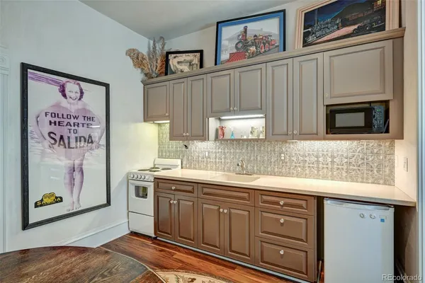 a kitchen with stainless steel appliances granite countertop a sink and a microwave